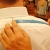 To measure sleeve length, first locate bone at nape of neck