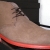 Tan suede desert boots with orange soles